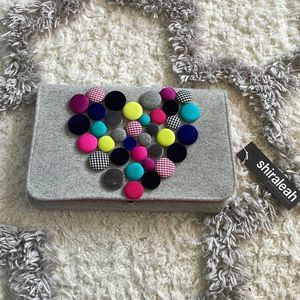 Woman’s Shiraleah heart shape button clutch bag